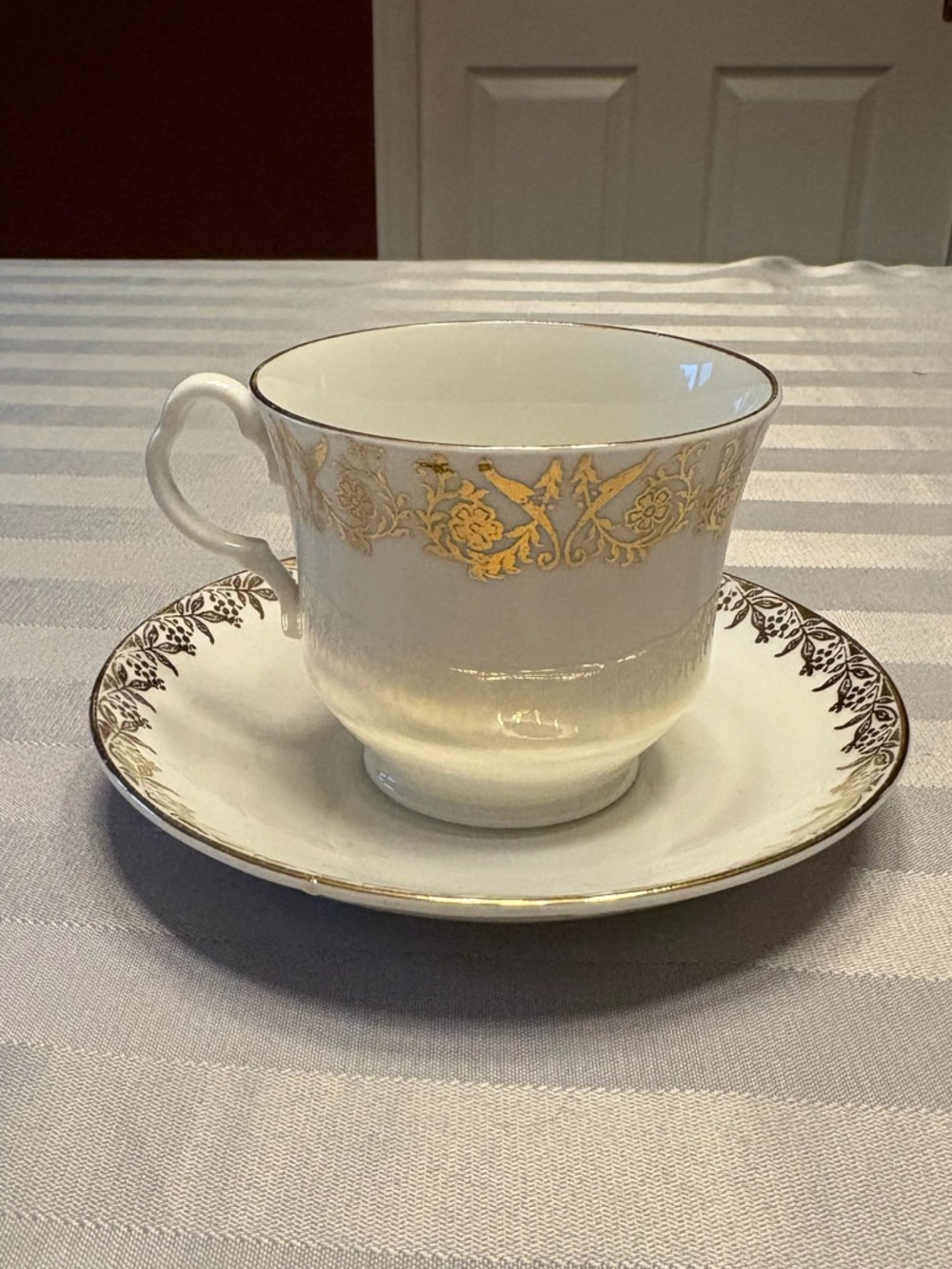 Elegant Gold-Trimmed White Bone China Teacup and Saucer